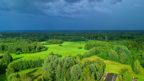 Aerial-Drone's-Pull-Out-Shot-Captures-Lush-Green-Fields-Beneath-Brilliant-Blue-Rain-Clouds