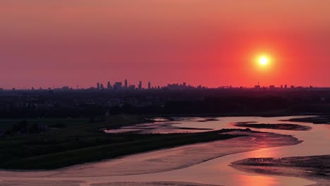 Stunning-view,-orange-and-red-sky-over-Rotterdam-and-the-calm-water-of-the-River-Noord