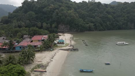 Dense-tropical-jungle-engulfs-tiny-beach-resort-on-Langkawi,-Malaysia