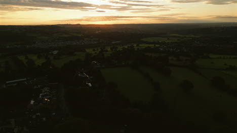 Establishing-Drone-Shot-Over-Fields-and-Houses-at-Sunrise