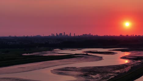 Cinematic-footage-of-red-and-orange-sky-above-Rotterdam-city-and-River-Noord