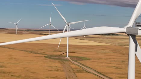 A-drone-flies-across-a-prairie-farmland-wind-farm-in-southern-Alberta,-Canada