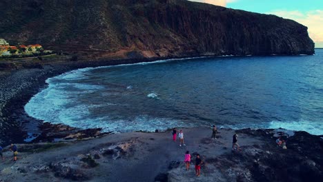 High-angle-shot-over-beautiful-beaches-along-steep-cliff-in-Tenerife-island,-Spain-during-evening-time