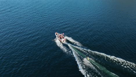 Overhead-aerial-view-of-a-motorboat-pulling-a-boogie-board
