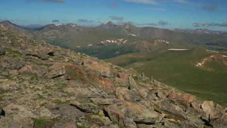 Cinematic-late-morning-view-Denver-Grays-and-Torreys-peak-Mount-Evans-snow-Summit-Echo-Chicago-lakes-14er-front-range-foothills-Rocky-Mountains-Idaho-Springs-wide-scenic-landscape-pan-to-the-right