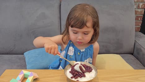 Adorable-Korean-Ukrainian-Little-Girl-Eating-Patbingsu---Milk-Based-Korean-Shaved-Ice-Dessert-with-Sweet-Red-Beans-Topping