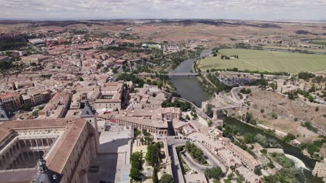 Aerial-flyover-of-Alcazar-de-Toledo,-overlooking-river-tagus