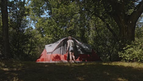 Slow-Motion-Shot-Of-Girl-Camping-In-Forest-Unzipping-The-Door-Of-Her-Tent,-Dunnet,-Scotland