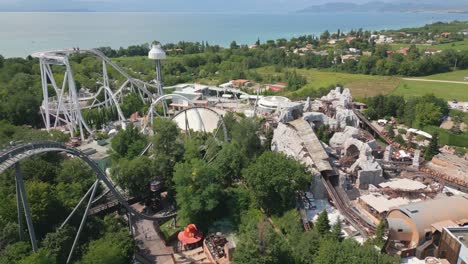 Aerial-Rotating-shot-of-Roller-Coasters-at-Gardaland-Amusement-Park-Resort-Near-Lake-Garda,-Italy