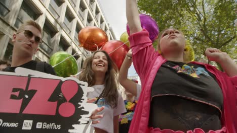 Camera-moving-from-left-to-right-showing-a-lot-of-people-dancing-and-having-fun-during-the-Antwerp-pride-parade-2023-in-Belgium