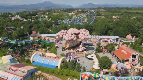 Vibrant-amusement-water-park-entrance-at-gardaland,-people-excited-to-play-and-relax