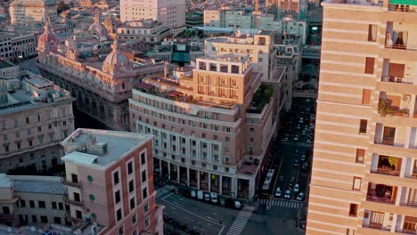 Aerial-view-at-sunset-over-historic-Piazza-Dante-with-street-activity,-Genoa