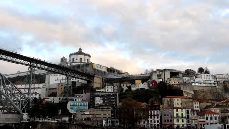Boat-trip-on-Douro-River-with-views-to-Dom-Luis-I-bridge-and-Serra-do-Pilar-Monastery,-Porto