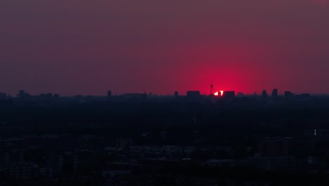 Red-skyline-over-a-city-and-building-silhouettes-below
