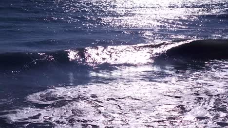 Seascape-with-sunlight-reflecting-on-sea-waves,-beautiful-background-of-sea-surface-at-twilight,-energy-of-seawater