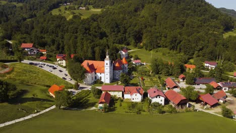 Medieval-monastery-and-church-in-small-town-Olimje-Slovenia,-aerial-orbit