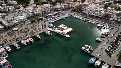 Drone-dolley-tilt-shot-over-the-busy-harbor-of-Elounda-at-daylight-in-Greece