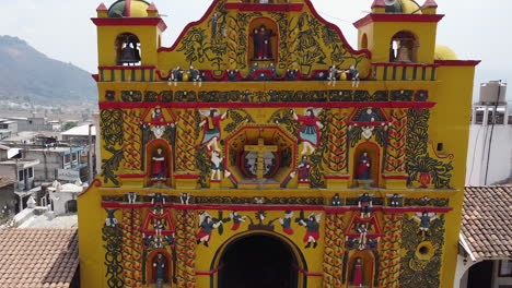 Ornate-detail-of-bright-yellow-Mayan-Church-façade-in-San-Andres-Xecul