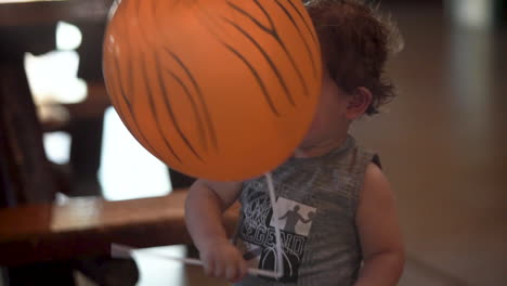 hispanic-biracial-toddler-baby-boy-child-with-orange-balloon