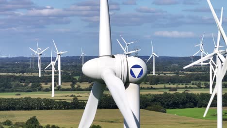 Turbinas-Eólicas-Que-Cultivan-Energía-Eólica,-Toma-De-Teleobjetivo,-Muchas-Turbinas-Girando-En-El-Fondo,-Energía-Verde-Sostenible,-Efecto-De-Paralaje