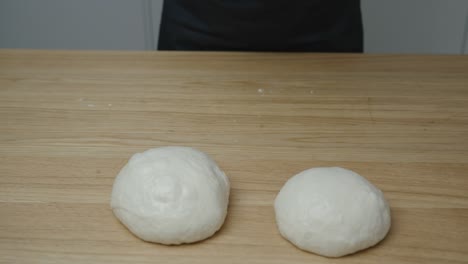 Man-forming-small-dough-balls-for-pizza-with-his-hands