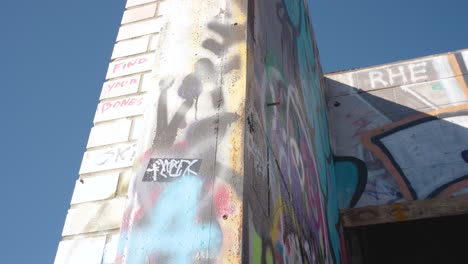 The-Camera-Tilts-Around-a-Graffiti-Covered-Cement-Building-Pillar-Outside-an-Abandoned-Business-Near-Kananaskis-Alberta-Canada