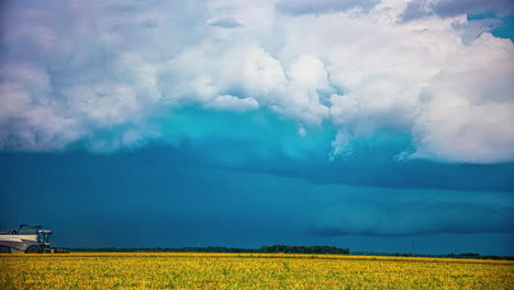 Rainy-weather-as-combine-harvester-gathers-crops---cloudscape-time-lapse