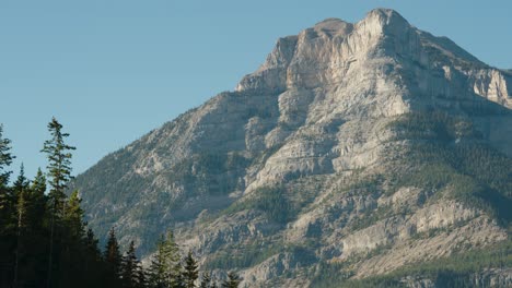 The-A-Large-Cliff-Face-of-the-Canadian-Rocky-Mountains-Tower-over-Cars-on-Canada's-Trans-Canada-Highway-One
