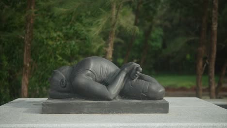 A-statue-of-a-person-lying-down-with-crossed-legs