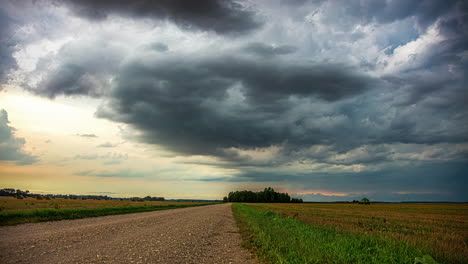 Summer-rainstorm-as-a-farmer-harvests-crops---dramatic-cloudscape-time-lase