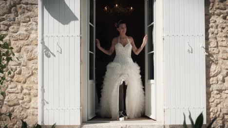 Slow-motion-shot-of-a-bride-exiting-the-building-in-her-beautiful-white-lace-dress