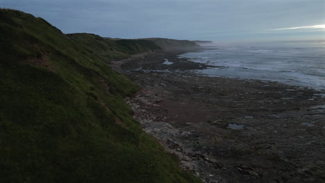 Establishing-Aerial-Drone-Shot-Close-to-Cleveland-Way-Cliffs-on-Misty-Morning-in-Scarborough