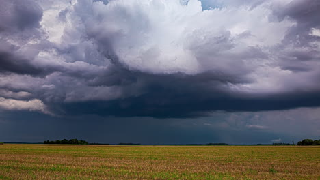 Stormy-weather-as-a-farmer-harvests-crops---dramatic-time-lapse