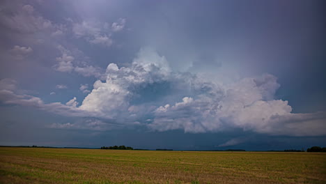 Combine-harvester-gather-crops-with-a-dramatic-cloudscape-overhead---time-lapse