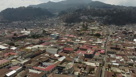 City-aerial-tilts-to-streets-of-Quetzaltenango-in-Guatemala-mountains