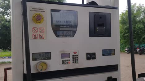 The-petrol-pump-station-fuel-meter-counter-closed-up-while-refueling-a-car,-increasing-petrol-costs