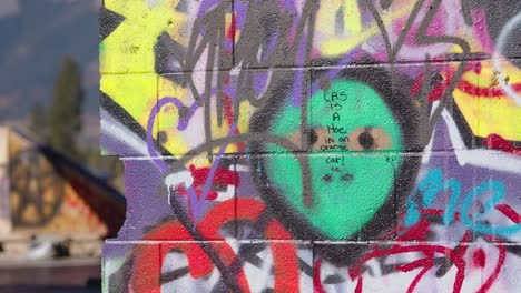 A-Graffiti-Painted-Green-Alien-Head-on-a-Concrete-Wall-in-the-Abandoned-Fort-Chiniki-Graffiti-Abandoned-Gas-Station-Near-Canmore-Alberta-Canada