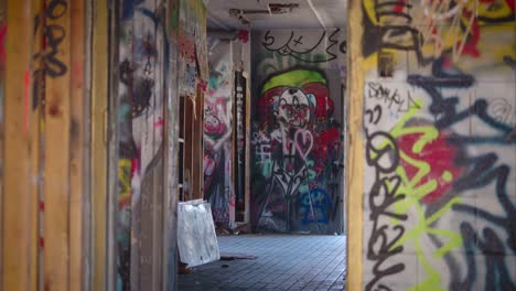 Camera-Rack-Focus-on-a-Scary-Looking-Graffiti-Drawing-Through-the-Doorway-of-an-Abandoned-Building-in-Canmore-Alberta-Canada