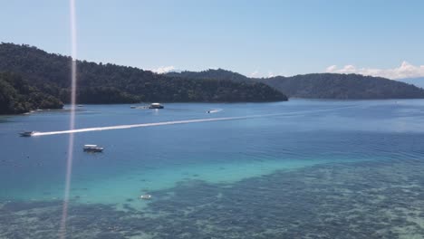 Aerial-View-Of-Tourists-Enjoying-Waters-Off-Gaya-Island-Beach