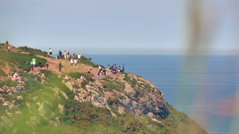 Locals,-visitors-and-tourists-enjoying-the-view-at-cliff-top-in-Howth,-Dublin