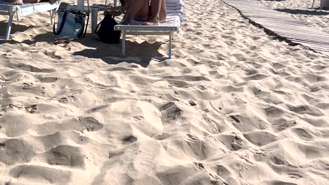 Hastily-searching-for-her-phone,-a-woman-intends-to-make-a-video-call-to-showcase-the-wonderful-beach-day-she's-experiencing,-capturing-the-eagerness-to-share-the-moment-with-others