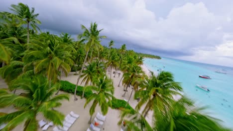 Flying-through-palm-trees-of-Saona-beach-in-Dominican-Republic-on-cloudy-day