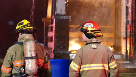 Two-firefighters-were-on-the-fire-site-watching-the-building-extinguishing-by-the-team