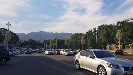 Busy-Street-Traffic-in-Downtown-of-Khujand,-Tajikistan-on-Sunny-Evening,-Wide-View