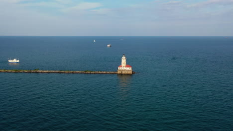 Aerial-view-flying-toward-Chicago-Harbor-Lighthouse,-summer-evening-on-Lake-Michigan