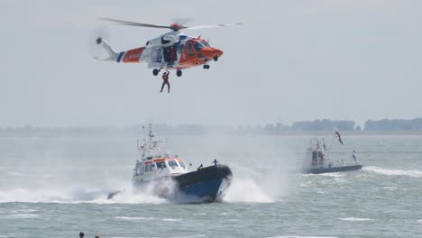 Person-Winched-into-SAR-Helicopter-from-Lifeboat-at-Sea,-KNRM-Display
