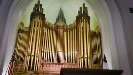 Explore-the-rich-heritage-of-a-church's-interior,-revealing-its-classic-pews-and-majestic-old-pipe-organ-in-intricate-detail