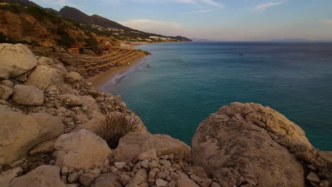 Rocky-hills-and-tourist-resorts-with-sea-view-at-evening-on-summer-vacation-beautiful-seaside-of-Ion-in-Albania,-Dhermi