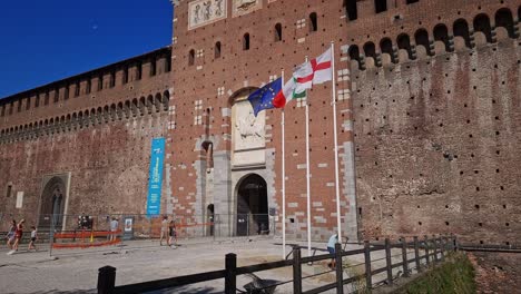 People-entering-the-medieval-fortification-Castello-sforzesco,-Milan