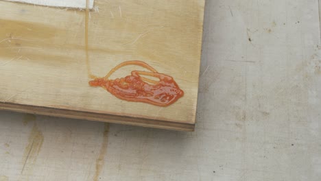 Pouring-Polyester-Resin-onto-corner-of-plywood-sheet